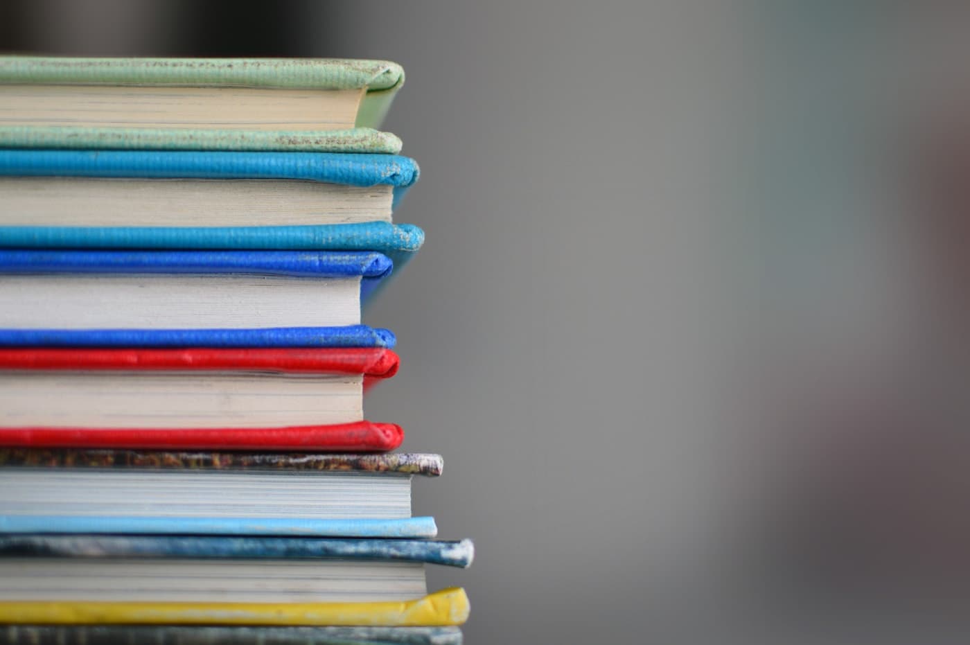 A stack of study books on a desk.